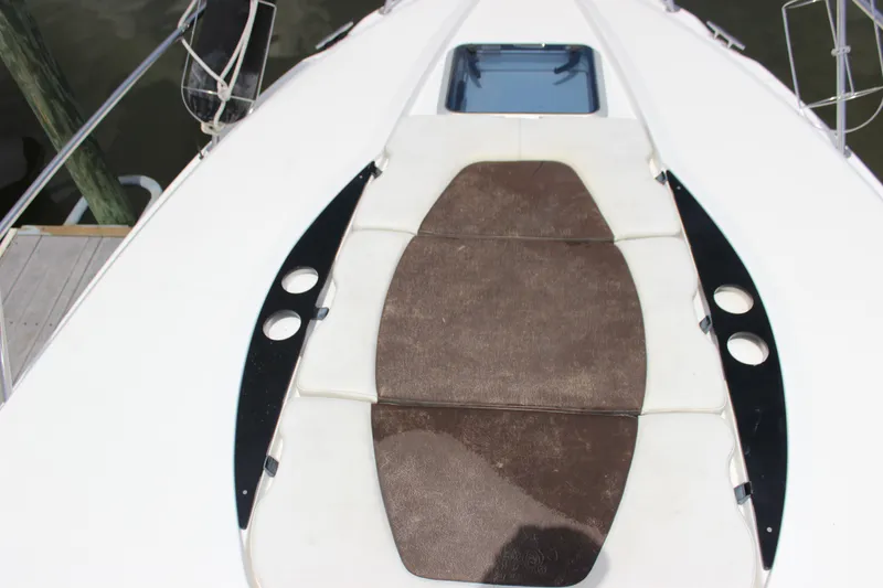 Slide: The Image of 2013 Rinker 31 boat deck with sun pad and hatch. - 9