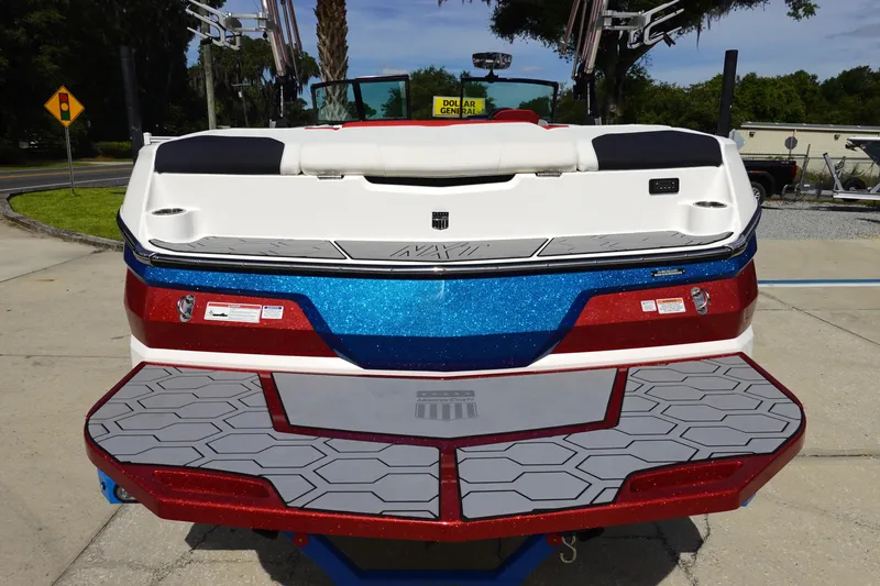 Slide: The Image of 2021 MasterCraft NXT22 boat rear view with blue and red accents. - 13