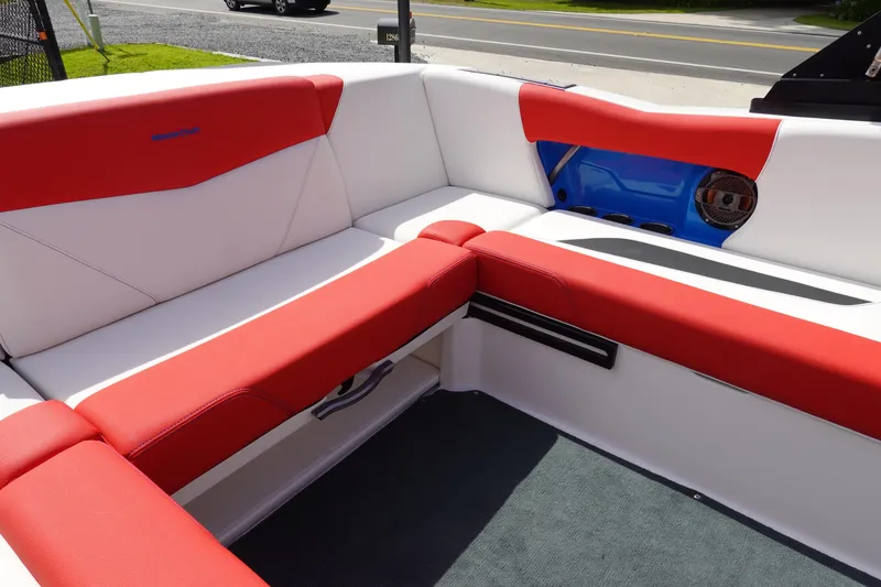 Slide: The Image of 2021 MasterCraft NXT22 boat interior with red and white seating. - 18