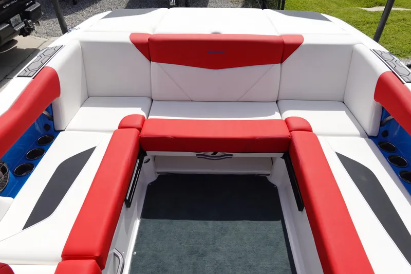 Slide: The Image of 2021 MasterCraft NXT22 boat interior with red and white seating. - 19