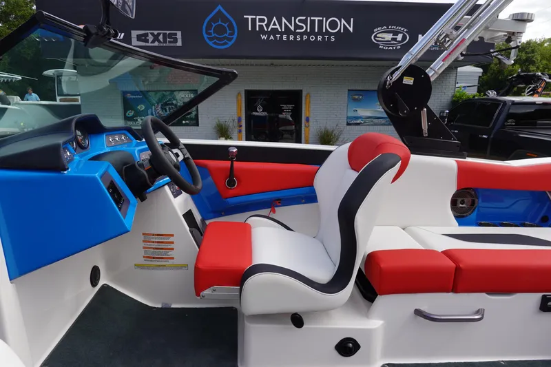 Slide: The Image of 2021 MasterCraft NXT22 boat interior with red, white, and blue seating at Transition Watersports. - 21