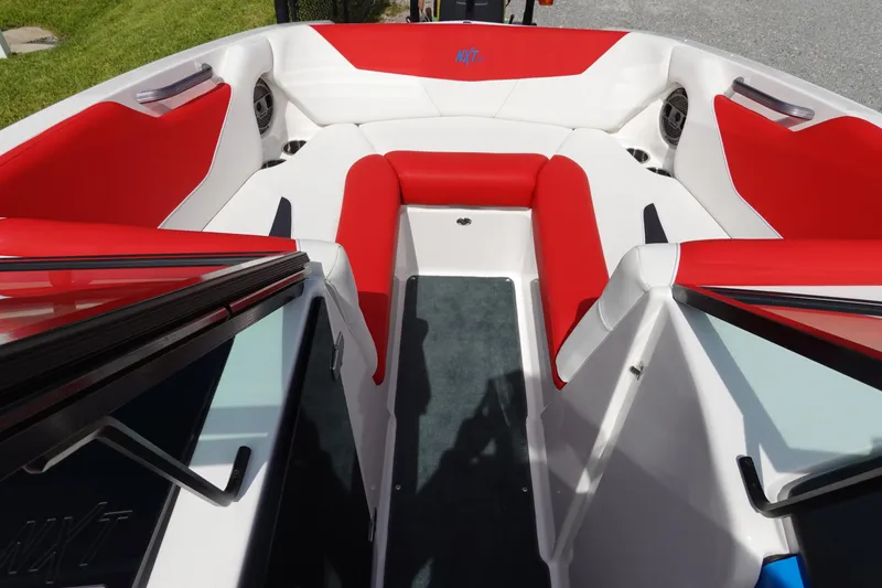 Slide: The Image of 2021 MasterCraft NXT22 boat interior with red and white seating. - 24