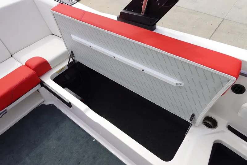 Slide: The Image of 2021 MasterCraft NXT22 boat with open storage compartment and red and white seating. - 31