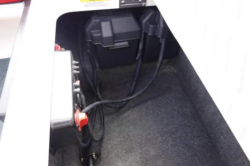 Slide: The Image of 2021 MasterCraft NXT22 battery compartment with wiring and components. - 32