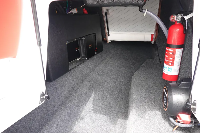 Slide: The Image of 2021 MasterCraft NXT22 boat interior storage compartment with fire extinguisher. - 34
