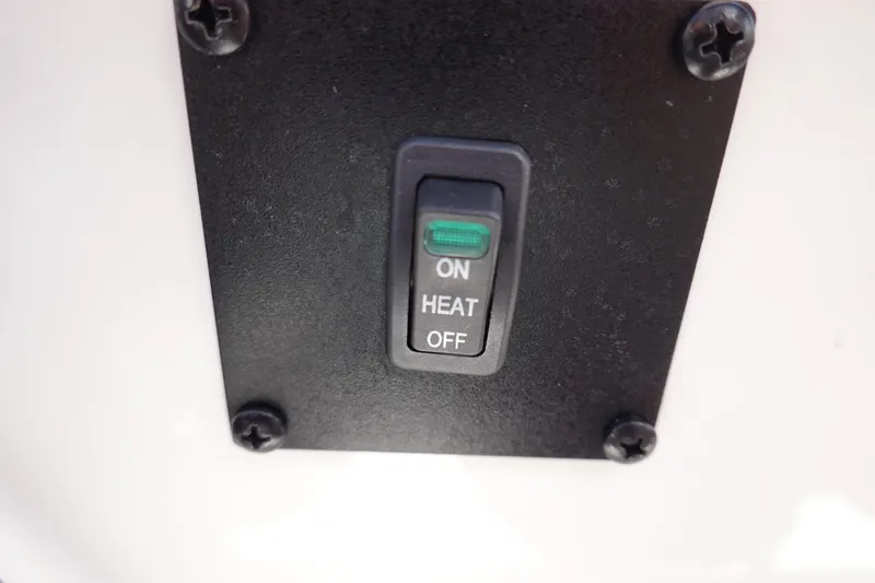 Slide: The Image of MasterCraft NXT22 2021 boat heater switch with ON, HEAT, and OFF options. - 46