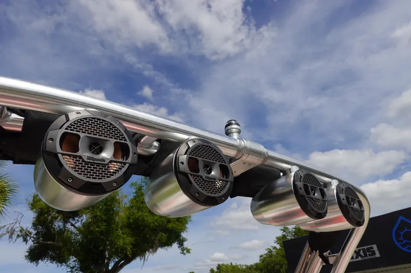 Slide: The Image of Close-up of 2021 MasterCraft NXT22 boat tower speakers against a blue sky. - 48
