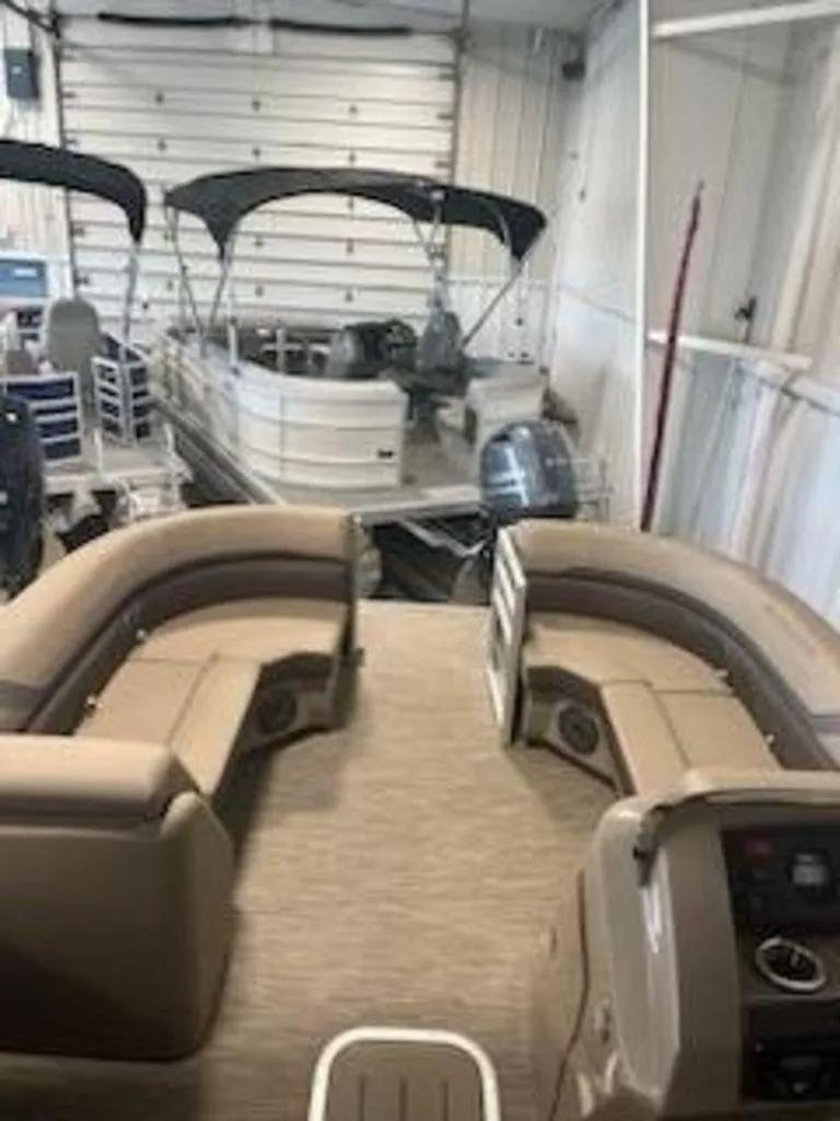 Slide: The Image of 2022 Bennington 22 SXSR SPS pontoon boat interior in a storage facility. - 4