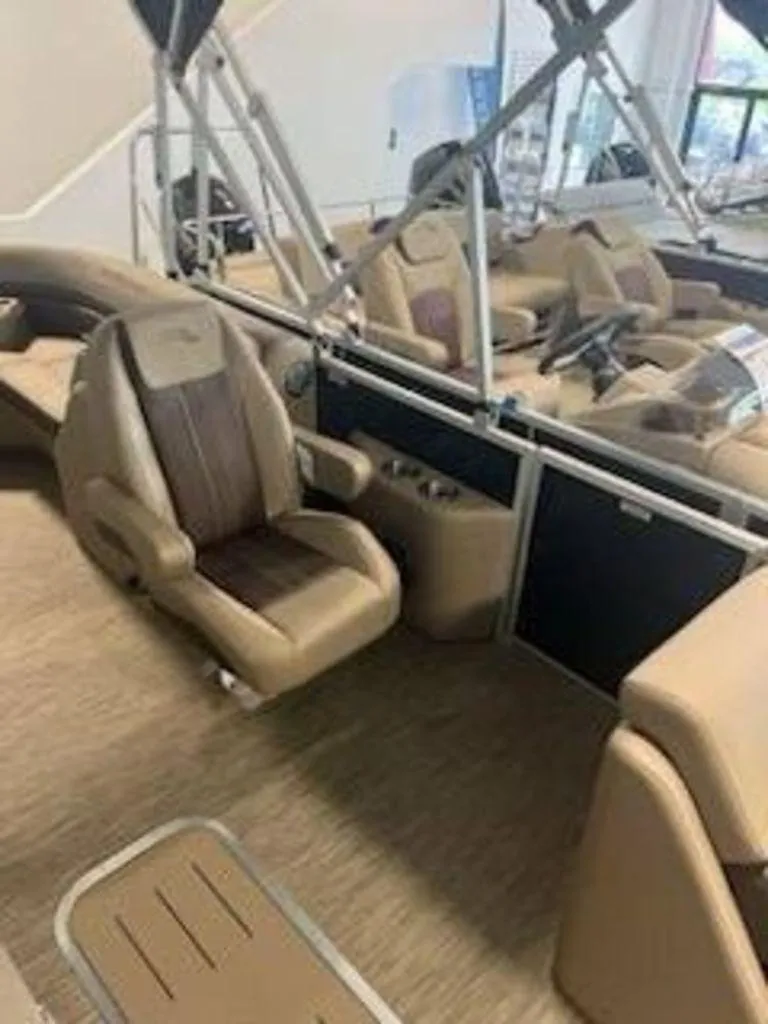 Slide: The Image of 2022 Bennington 22 SXSR SPS pontoon boat interior with tan seating and helm. - 5