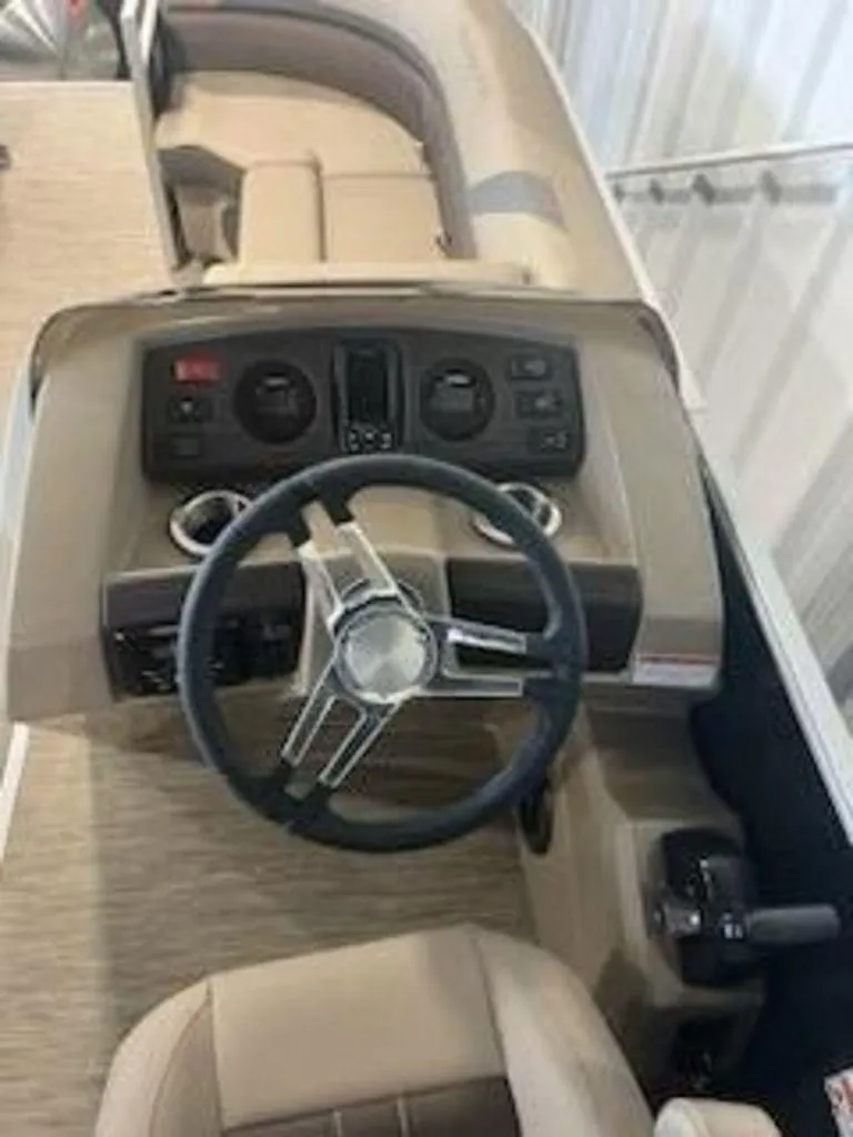 Slide: The Image of 2022 Bennington 22 SXSR SPS boat interior with steering wheel and dashboard. - 8