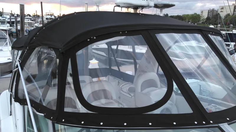 Slide: The Image of 2004 Sea Ray 340 Sundancer with black canvas enclosure at marina. - 11