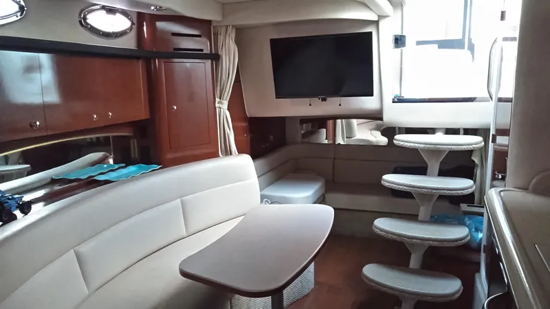 Slide: The Image of Interior of 2004 Sea Ray 340 Sundancer yacht with seating, table, and stairs. - 26