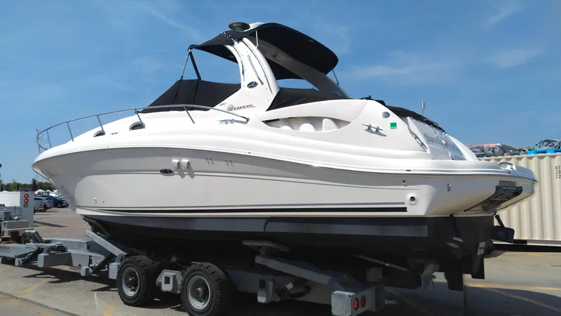 Slide: The Image of 2004 Sea Ray 340 Sundancer boat on a trailer in a marina. - 5
