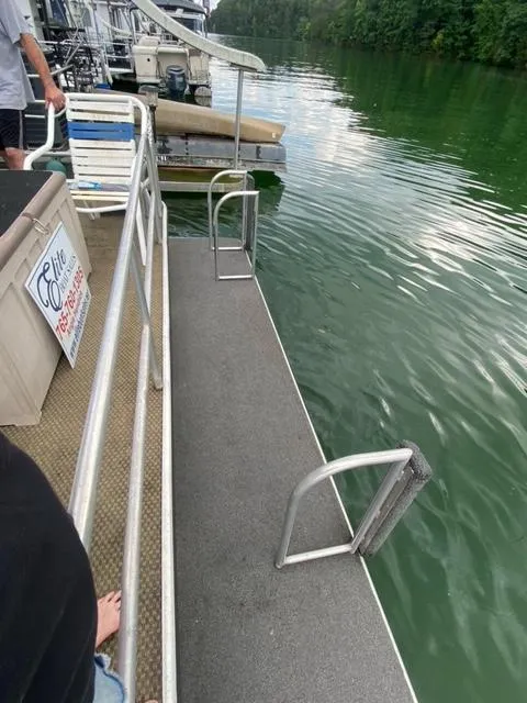 Slide: The Image of 1984 Sumerset Houseboat 14 x 60 docked on a serene lake. - 20