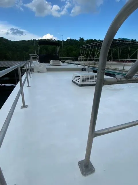 Slide: The Image of 1984 Sumerset Houseboat 14 x 60 rooftop deck with railings and air conditioning unit. - 22