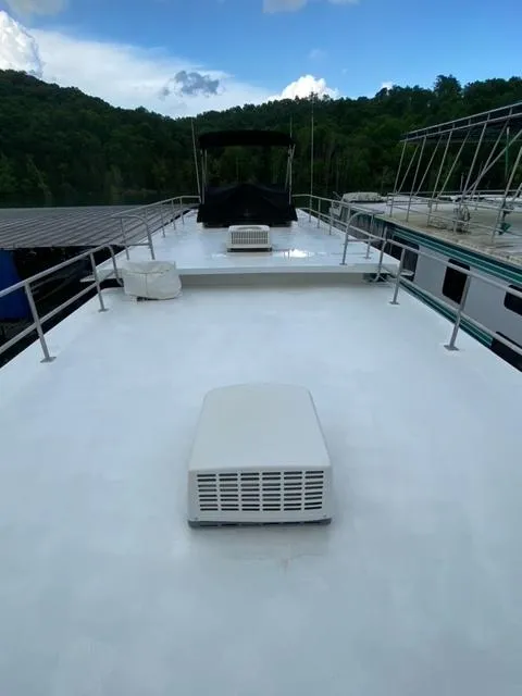 Slide: The Image of 1984 Sumerset Houseboat 14 x 60 rooftop with air conditioning unit and scenic background. - 23