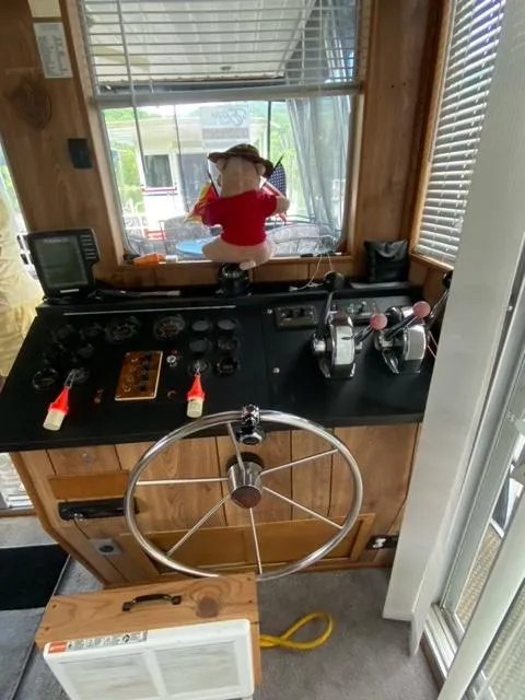 Slide: The Image of 1984 Sumerset Houseboat 14 x 60 helm with steering wheel and control panel. - 8