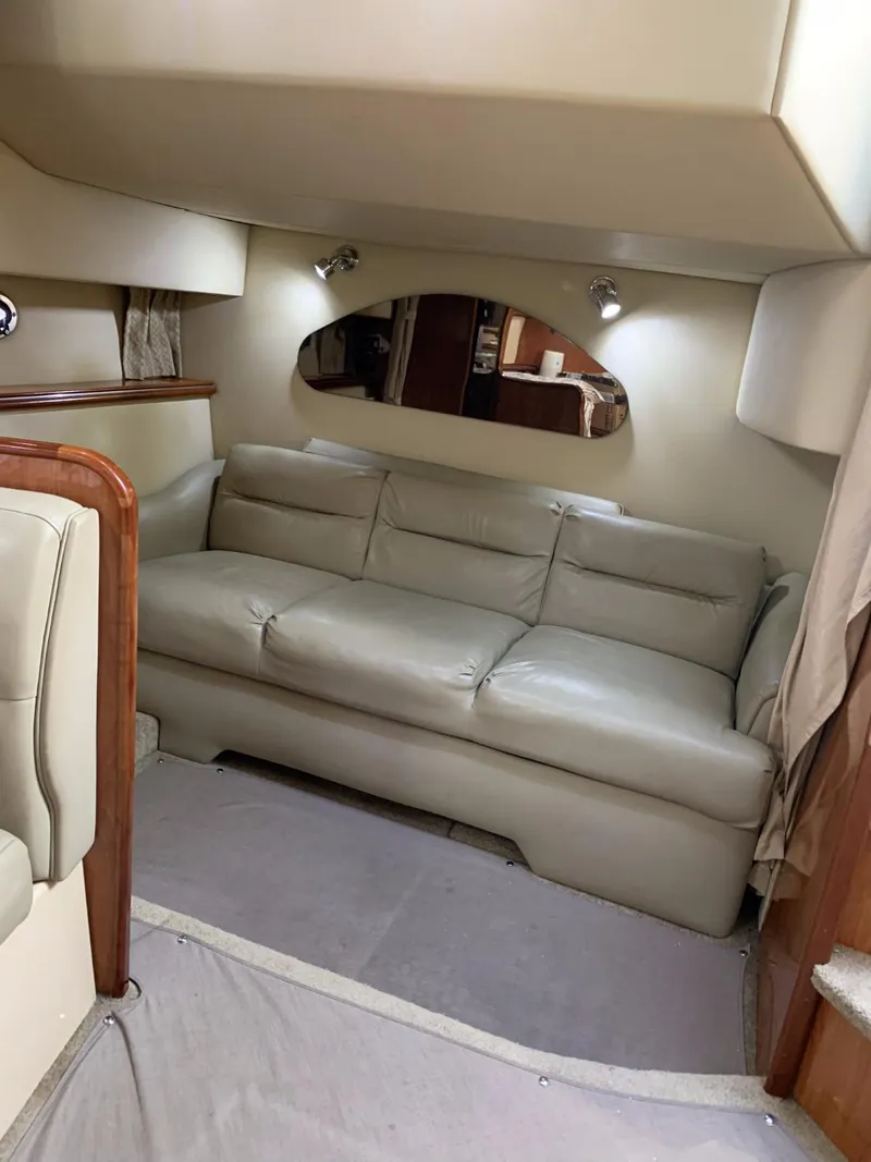 Slide: The Image of 2006 Cruisers 320 Express cabin interior with beige leather sofa. - 20