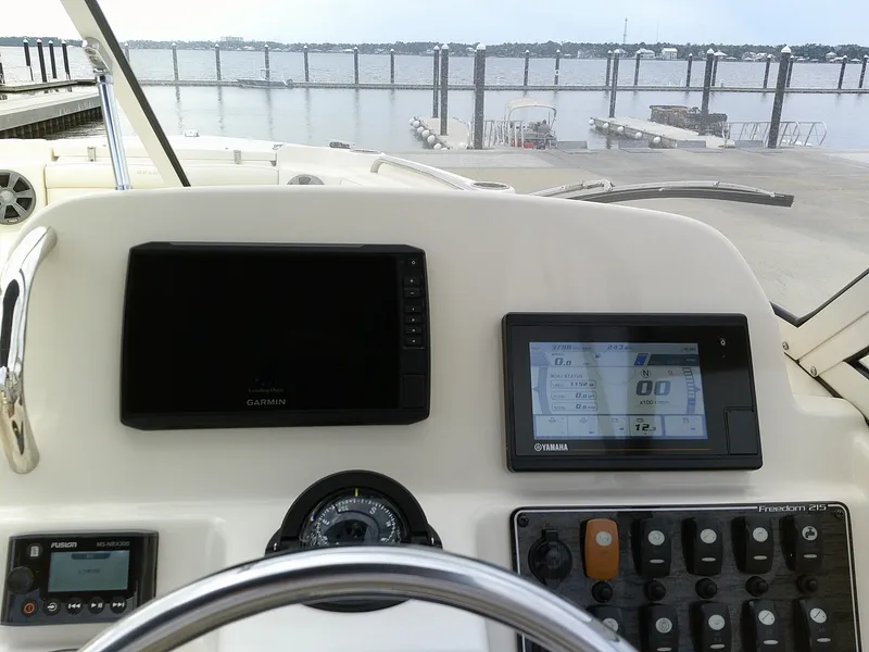 Slide: The Image of 2019 Grady-White Freedom 215 boat dashboard with Garmin and Yamaha displays. - 11
