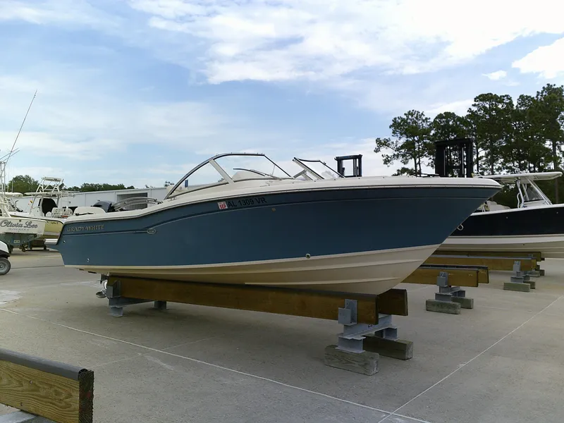 Slide: The Image of 2019 Grady-White Freedom 215 boat on display in a marina. - 2