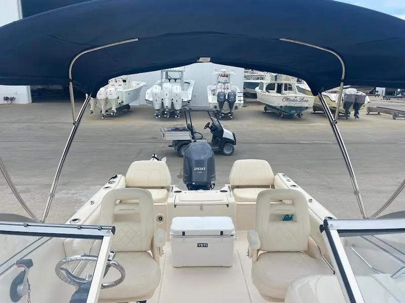 Slide: The Image of 2019 Grady-White Freedom 215 boat interior with seating and outboard motor. - 6