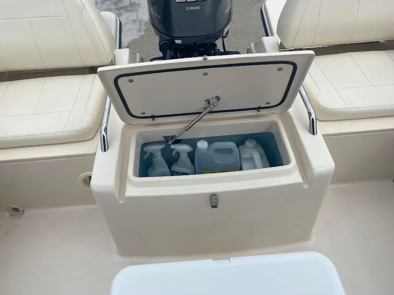 Slide: The Image of 2019 Grady-White Freedom 215 boat storage compartment with cleaning supplies. - 8