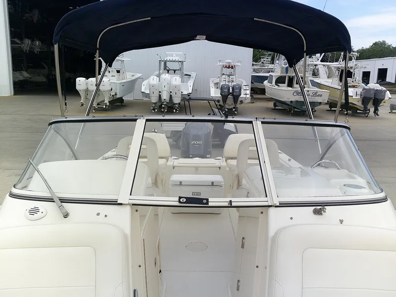 Slide: The Image of 2019 Grady-White Freedom 215 boat with bimini top, docked at a marina. - 9