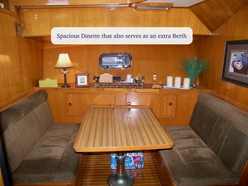 Slide: The Image of Spacious dinette in 1984 Symbol 51 yacht, convertible to extra berth, with wood finish and cozy seating. - 20