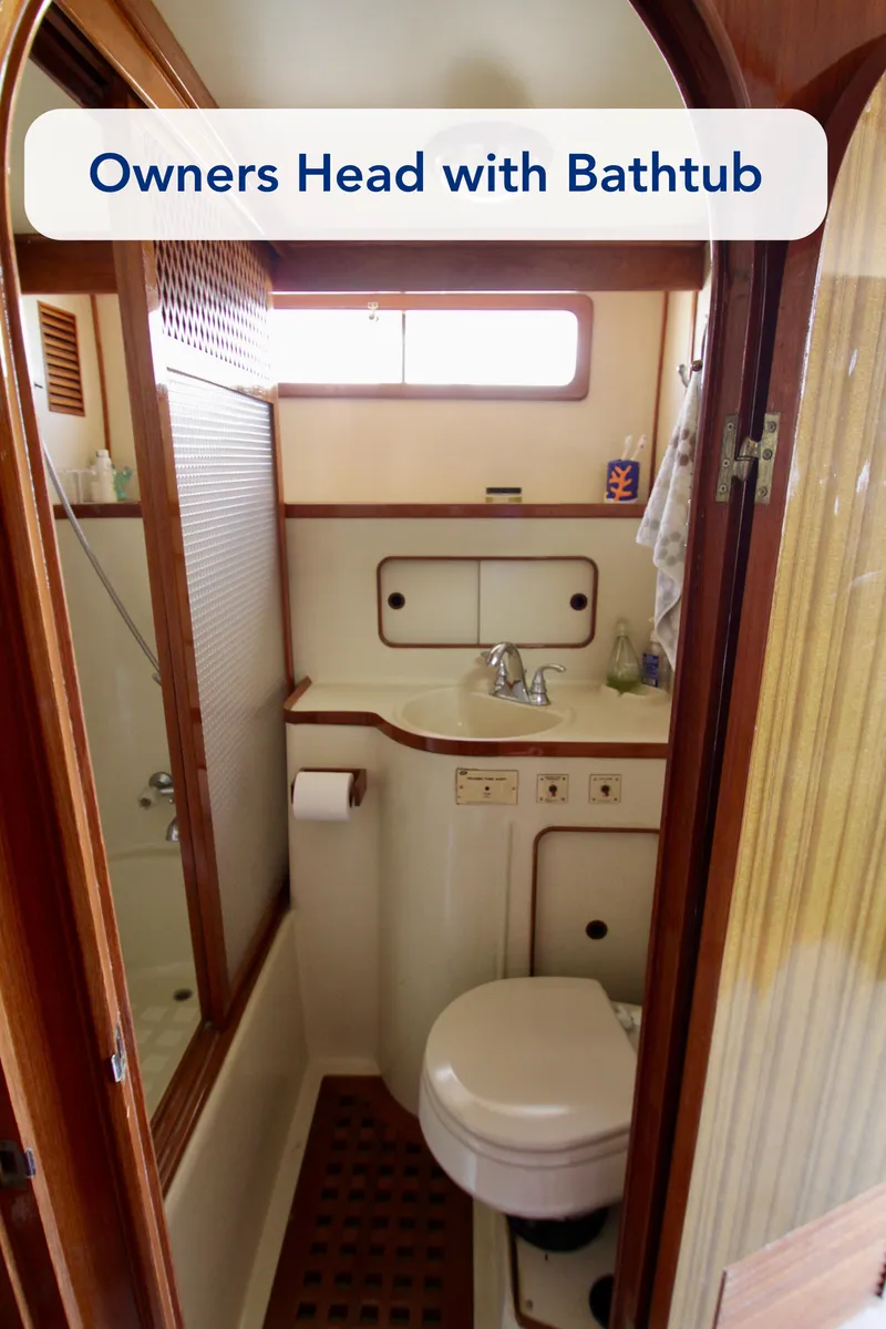 Slide: The Image of 1984 Symbol 51 yacht bathroom with bathtub, sink, and toilet. - 33