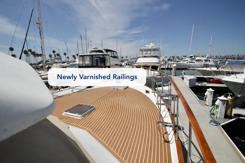 Slide: The Image of Newly varnished railings on a 1984 Symbol 51 yacht in a marina. - 5