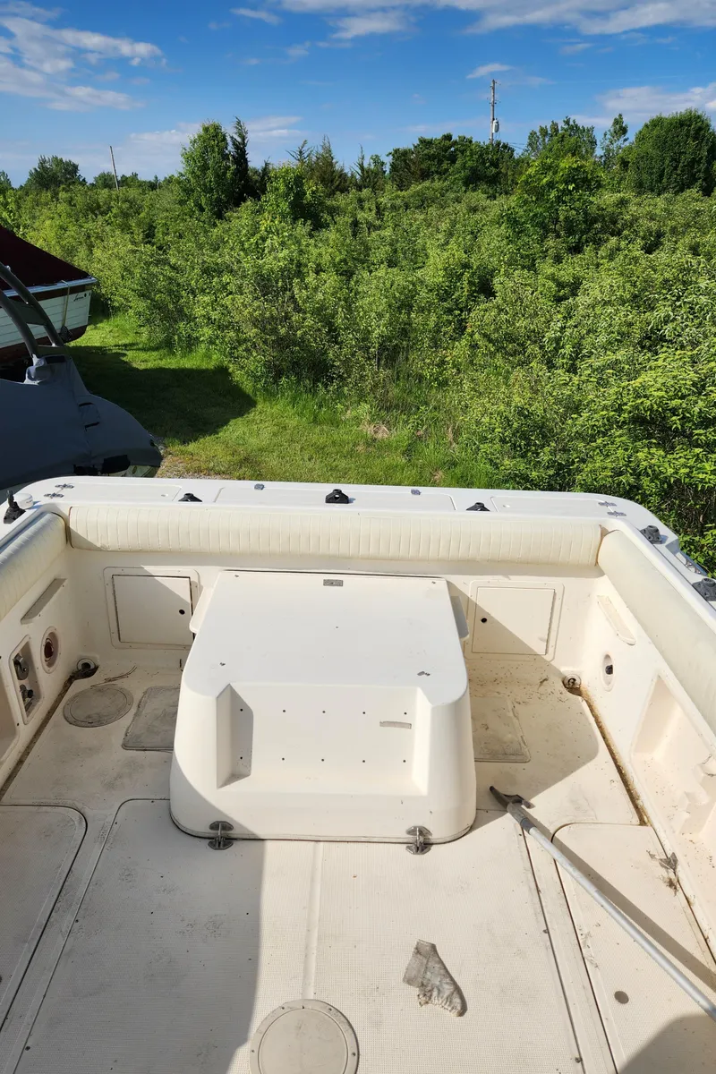 Slide: The Image of 1999 Renken 2788 boat interior with white seating and storage compartments. - 11