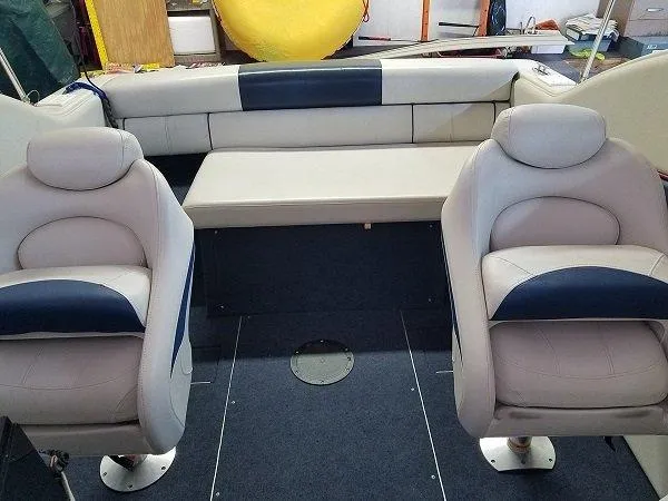 Slide: The Image of 1992 Crownline 210 CCR boat interior with beige and blue seating. - 11