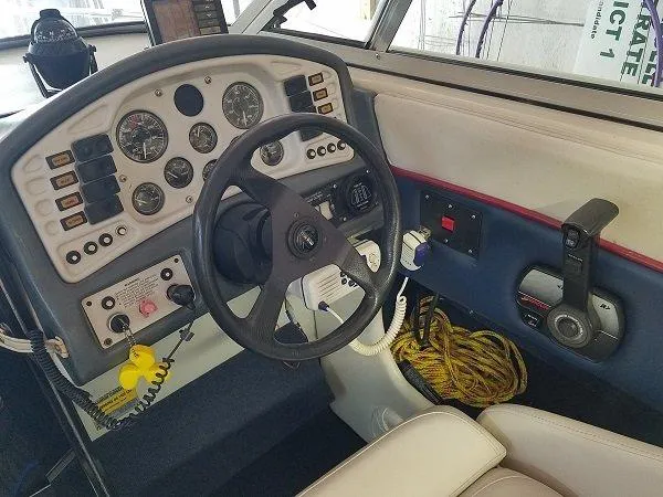Slide: The Image of 1992 Crownline 210 CCR boat cockpit with steering wheel and control panel. - 2