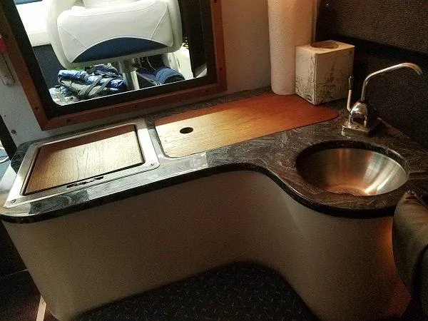 Slide: The Image of Compact kitchen area in a 1992 Crownline 210 CCR boat with sink and countertop. - 5