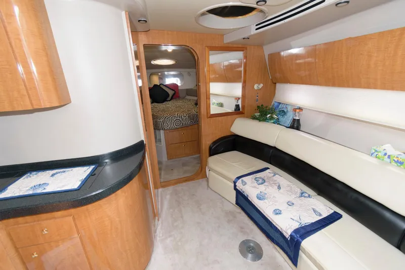 Slide: The Image of Interior of 2002 Regal Commodore 3860 yacht with modern furnishings and cozy seating area. - 10