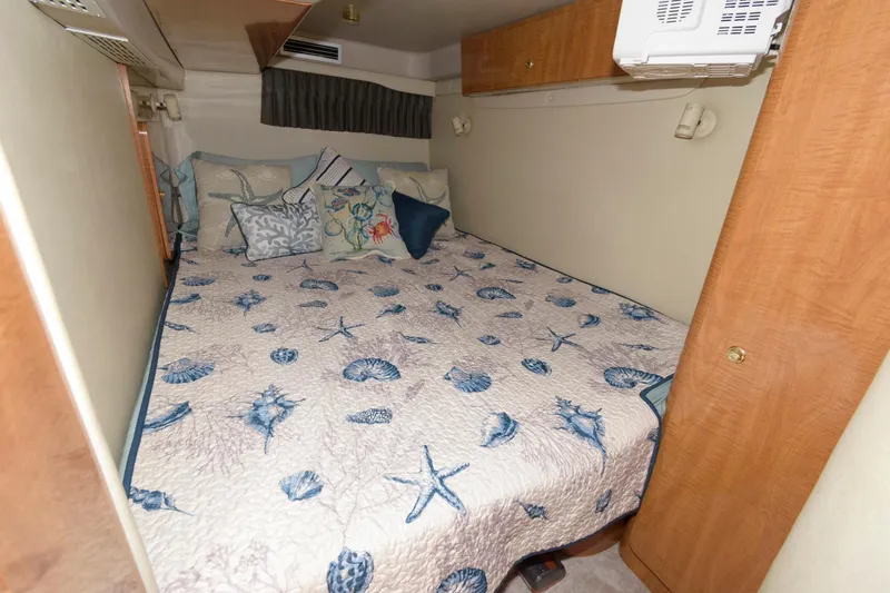 Slide: The Image of Cozy bedroom in 2002 Regal Commodore 3860 yacht with seashell-themed bedding. - 17