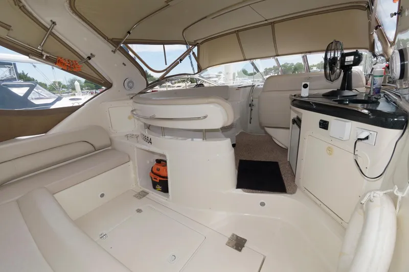 Slide: The Image of Interior of 2002 Regal Commodore 3860 yacht with seating, kitchenette, and helm station. - 2