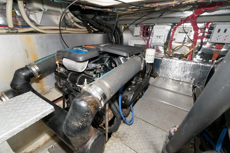 Slide: The Image of Engine room of a 2002 Regal Commodore 3860 yacht with visible machinery. - 22