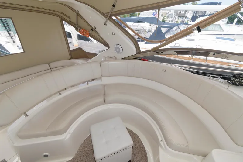 Slide: The Image of Interior seating area of 2002 Regal Commodore 3860 yacht with white leather upholstery. - 4