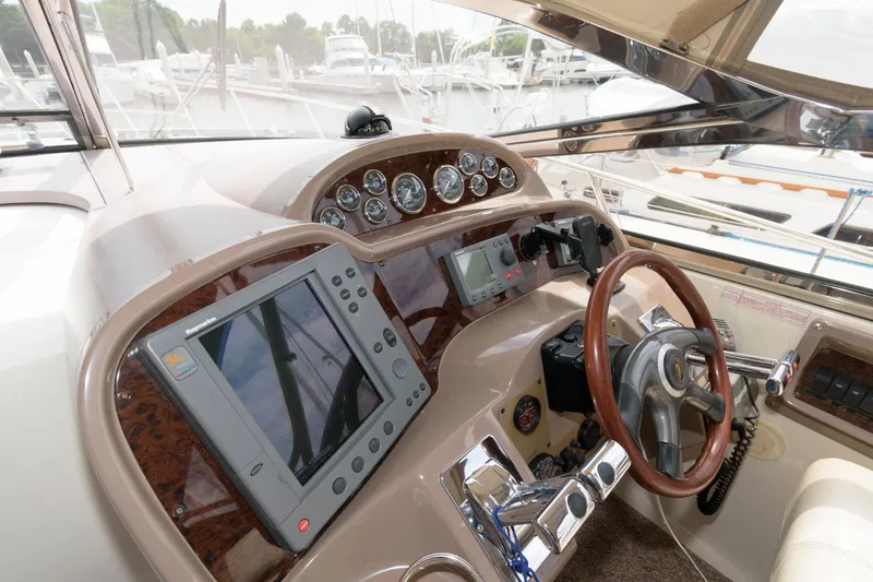 Slide: The Image of 2002 Regal Commodore 3860 yacht helm with advanced navigation system and wooden steering wheel. - 7