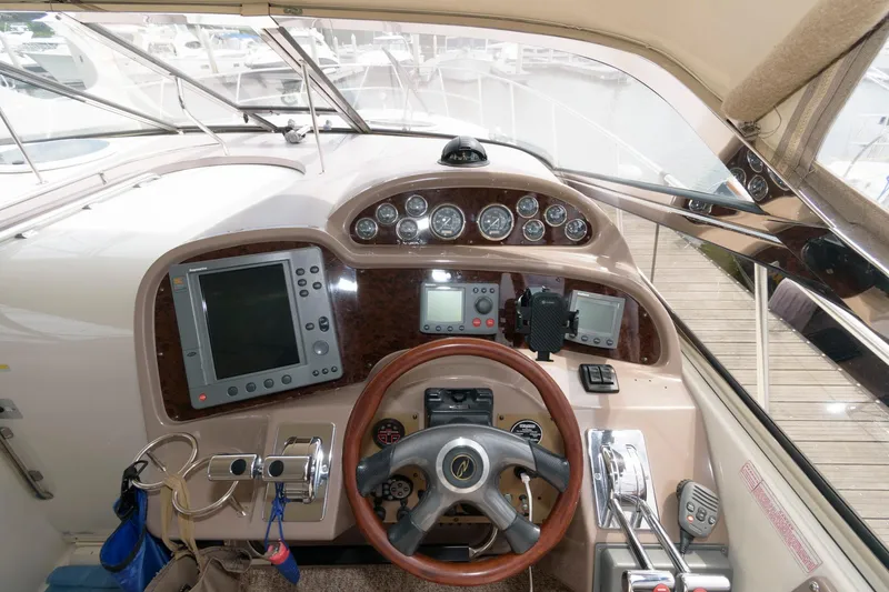 Slide: The Image of 2002 Regal Commodore 3860 boat helm with navigation instruments and controls. - 8