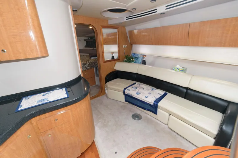 Slide: The Image of Interior of 2002 Regal Commodore 3860 yacht with modern seating and wooden cabinetry. - 9
