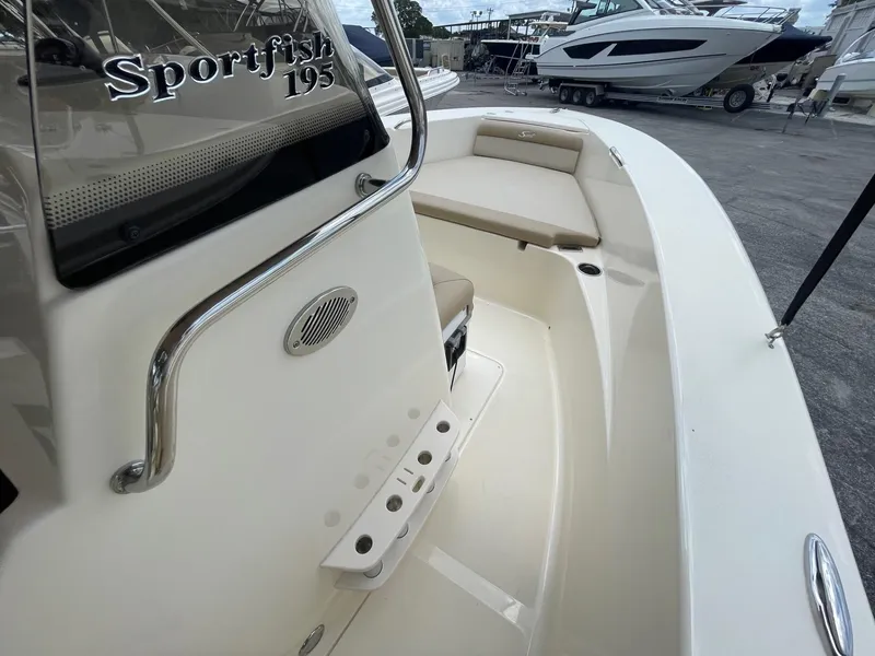 Slide: The Image of 2024 Scout 195 Sportfish boat interior, featuring seating and storage areas. - 12