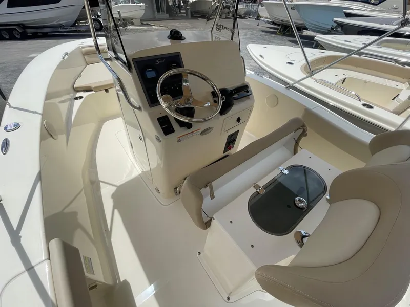 Slide: The Image of 2024 Scout 195 Sportfish boat interior with steering console and seating. - 6