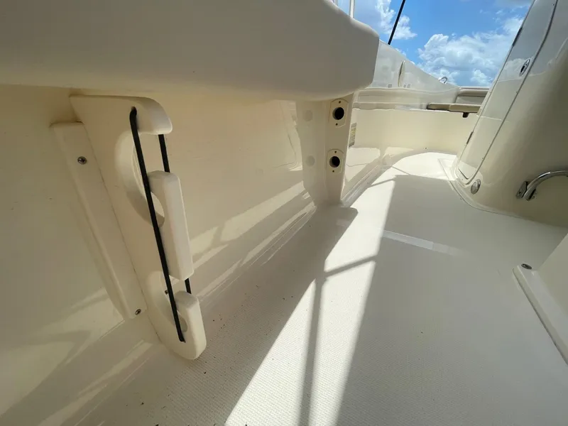 Slide: The Image of 2024 Scout 195 Sportfish boat interior with white deck and storage compartments. - 7