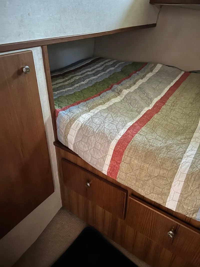 Slide: The Image of Cozy bedroom in 1994 Bayliner 4788 yacht with striped bedding. - 10