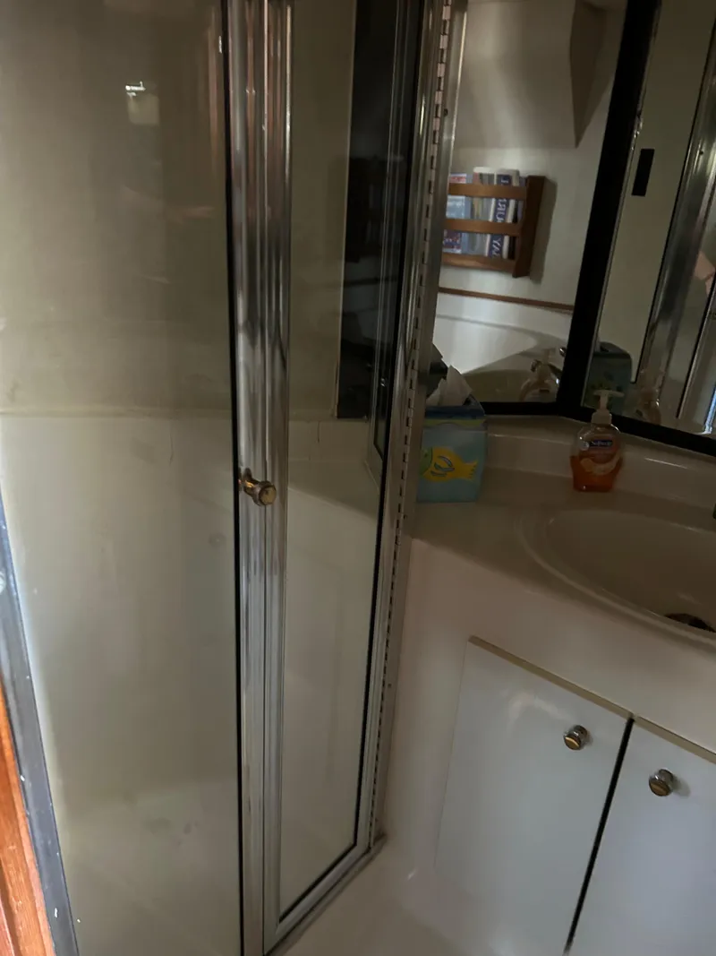 Slide: The Image of Bathroom in a 1994 Bayliner 4788 yacht with shower and sink. - 14