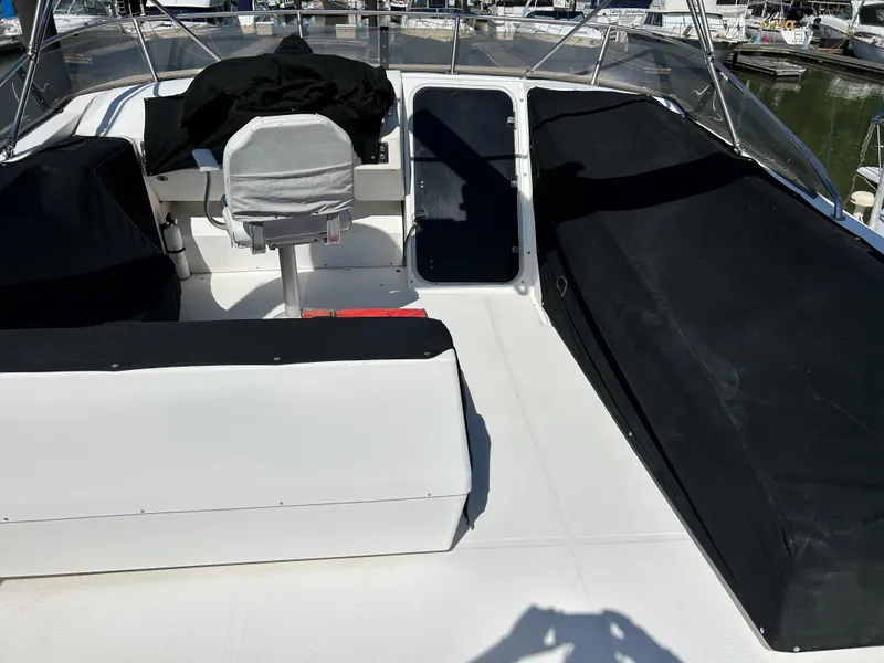 Slide: The Image of 1994 Bayliner 4788 boat cockpit with seating and covered areas. - 2