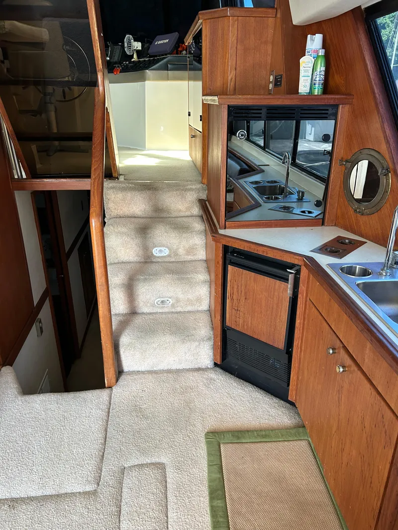 Slide: The Image of Interior of 1994 Bayliner 4788 yacht with carpeted stairs and wooden cabinetry. - 20