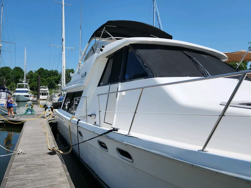 Slide: The Image of 1994 Bayliner 4788 yacht docked at marina on a sunny day. - 25